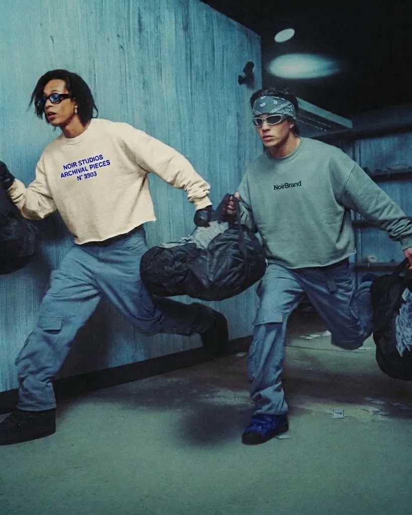 Campaña NoirBrand: dos modelos corriendo con las piezas del Drop 001